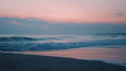 Fototapeta premium Tranquil ocean sunset with soft focus waves and pastel sky for serene background setting.