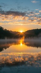 Naklejka premium Serene Sunrise Over Calm Lake with Reflection and Mist, Beautiful Natural Landscape at Dawn with Vibrant Sky and Tranquil Water Scene