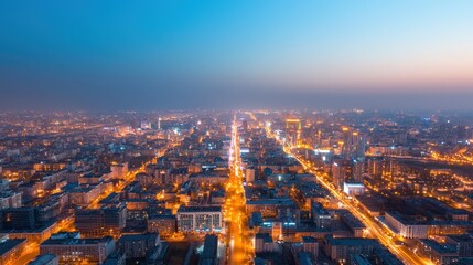 Energy consumption and electricity data, A stunning aerial view of a city at dusk, illuminated by streetlights and buildings, showcasing a vibrant urban landscape transitioning from day to night.