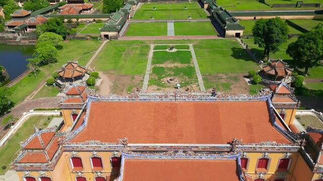 The Kien Trung Palace, nestled within the lush grounds of the Hue Imperial City, showcases vibrant architecture and intricate detailing amidst expansive greenery.
