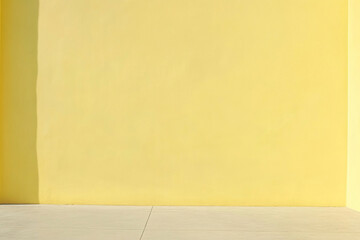 An empty yellow wall and tiles on the floor