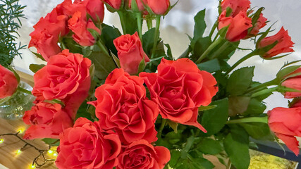 A vibrant bouquet of red roses in a glass vase, perfect for celebrating Valentine's Day or romantic occasions