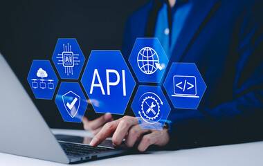 API Application Programming Interface Concept. A programmer types on a laptop, interacting with digital icons representing API development, security, and cloud computing. Application Software Tool,