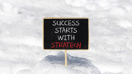 Success starts with strategy symbol. Concept words Success starts with strategy on beautiful blackboard. Beautiful snow background. Business and success starts with strategy concept. Copy space.