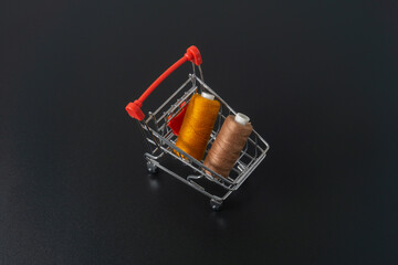 Spun polyester sewing thread on black background