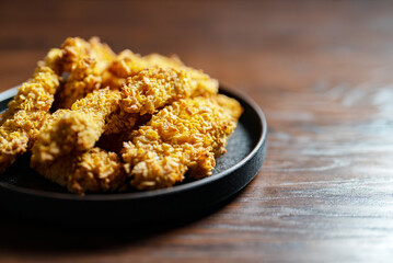 Crispy chicken strips with a golden crust.