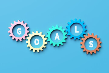 Colorful interlocking gears spelling goals on blue background