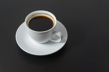 A cup of americano coffee on black background