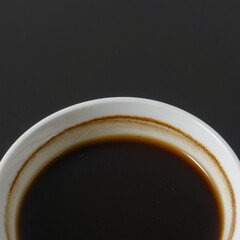 A cup of americano coffee on black background