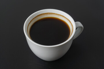 A cup of americano coffee on black background