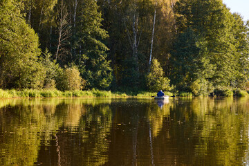 Fishing in a Boat on Calm Forest Lake