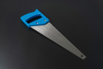 Handsaw on black background