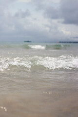 Sea view with small waves in cloudy weather. Balearic Sea, Salou, Spain. View of the waves on the sea from a lower angle. Landscape with sea and clouds
