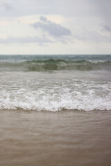 Sea view with small waves in cloudy weather. Balearic Sea, Salou, Spain. View of the waves on the sea from a lower angle. Landscape with sea and clouds