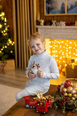 Happy cute child, girl on Christmas, enjoying christma holidays at a beautiful decorated home