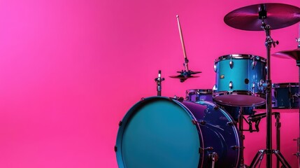 Blue and purple drum set displayed against a vibrant pink background