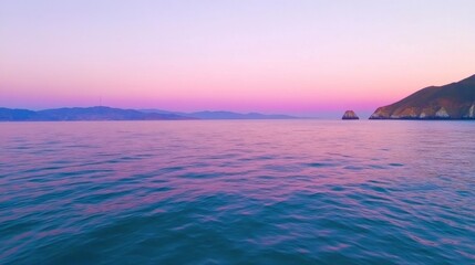Fototapeta premium Serene Twilight Over Calm Sea with Gentle Waves and Distant Hills
