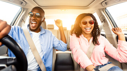 Summer Holidays And Roadtrip Concept. Front view portrait of excited black couple in sunglasses...