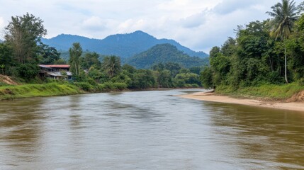 Serene River Flowing Through Lush Green Landscape Under Cloudy Sky