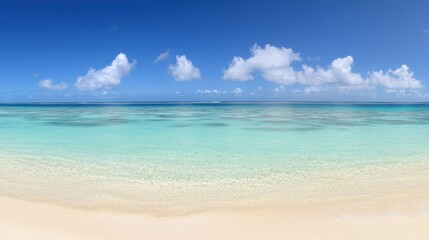 Fototapeta premium Serene Tropical Beach with Clear Blue Water and White Sand under Blue Sky