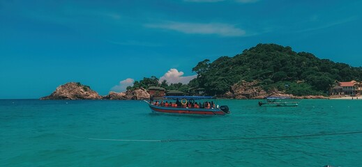 Redang Island, Malaysia, with its white sand beach, turquoise water, and boats