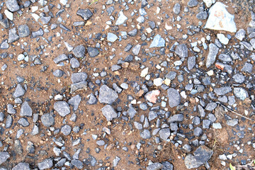 Old small stone floor texture and background. Close up exterior natural ground surface texture idea concept. Top view. Mud.