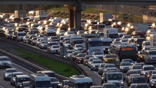 City traffic time lapse in sunset. City traffic at rush hour. Heavy evening traffic. Cars trying to reach home at rush hour. Blurred background and glittering chaos.

