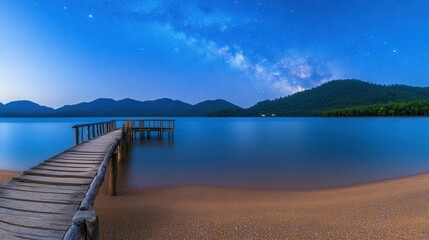 Obraz premium Serene Lake View Under Starry Sky with Wooden Pier and Mountains