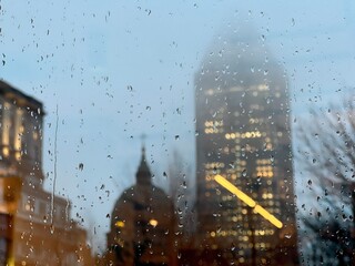 The raindrops on the window with downtown skyscrapers in the background. Montreal, Quebec, Canada