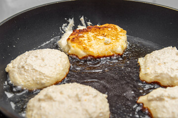 Cheesecakes or pancakes are fried in a frying pan