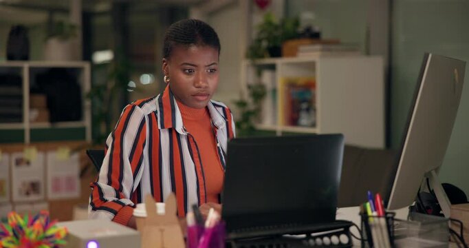 Black woman, laptop and working at night in office with ux check and update on company website. Research, admin and professional with project deadline and web designer with technology and page review