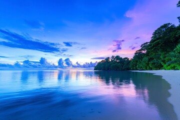 Sunset reflection over tranquil beach tropical island nature photography serene environment wide angle view peaceful concept