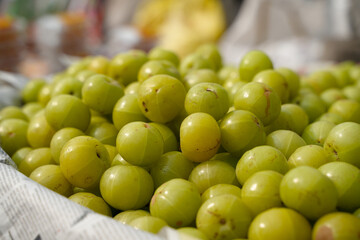 Many amlaki fruits are being sold in the market. This is the result Also known as Indian...