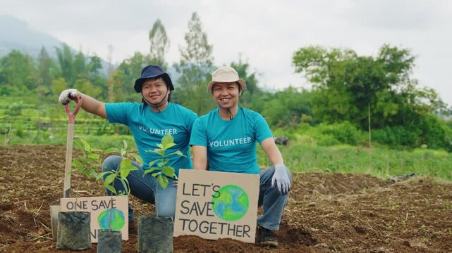 Portrait of Two Activists with Save Earth Posters. Happy Volunteers Ready for Reforestation to Fight Climate Crisis. Tree planting, global warming, nature care, eco initiatives, save the planet