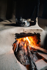 COOKING KETTLE ON THE WOOD FIRE IN A SHELTER IN THE MOUNTAINS OF THE HIMALAYA NEPAL