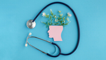A stethoscope is placed on top of a head with a flower