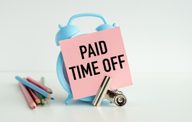 A blue alarm clock with pink writing on it that says Paid Time Off