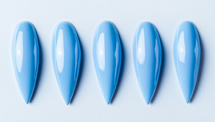 Fototapeta premium Light Blue Pointed Manicure Nails on White Background