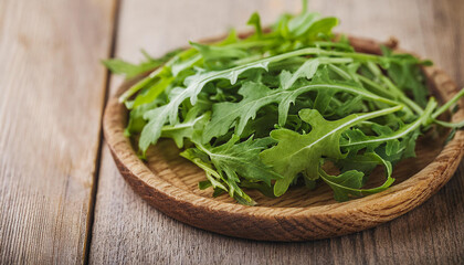 Green arugula on wooden plate. Healthy and natural product. Rucola leaves.