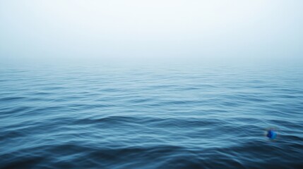 Obraz premium Tranquil Seascape with Gentle Waves and Soft Foggy Atmosphere