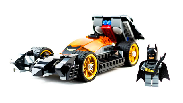Lego toy Batman with Batmobile. Studio shot on white background.