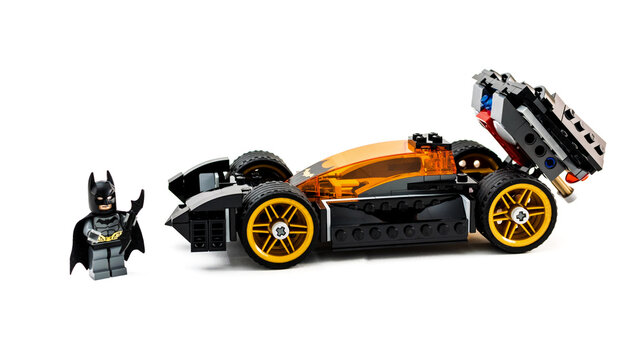Lego toy Batman with Batmobile. Studio shot on white background.