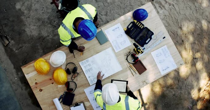 Above, people and paper on construction site for planning, urban development and project management with tech. Engineer team, blueprint or talking at equipment for building renovation in architecture - Powered by Adobe