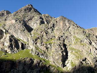 Walkers on the hiking trail by Riffelsee lake with the Matterhorn in the background. Zermatt, Switzerland. Europe

