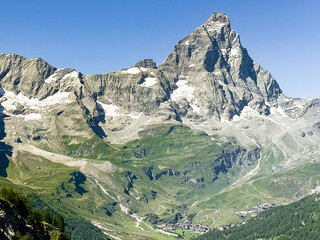 Walkers on the hiking trail by Riffelsee lake with the Matterhorn in the background. Zermatt,...
