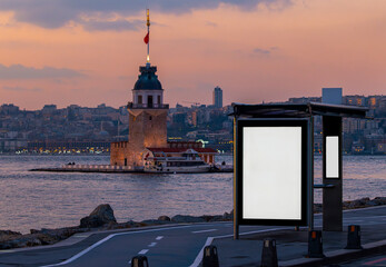 Maiden's Tower in the background and bus stop advertising board in the at sunset, Istanbul, Turkey