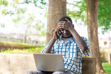 young African American man making use on laptop computer.
