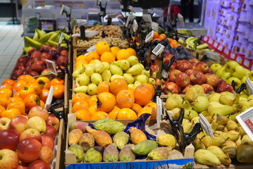 The produce section of a supermarket. Displays from crisp green lettuce and broccoli to bright red...