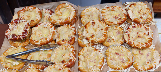 Freshly baked pretzels topped with melted cheese and bacon