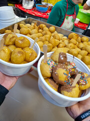 Close-up view of Loukoumades dessert, greek donuts with honey and walnut, traditional greek lokma sweets  in corfu island , Greece